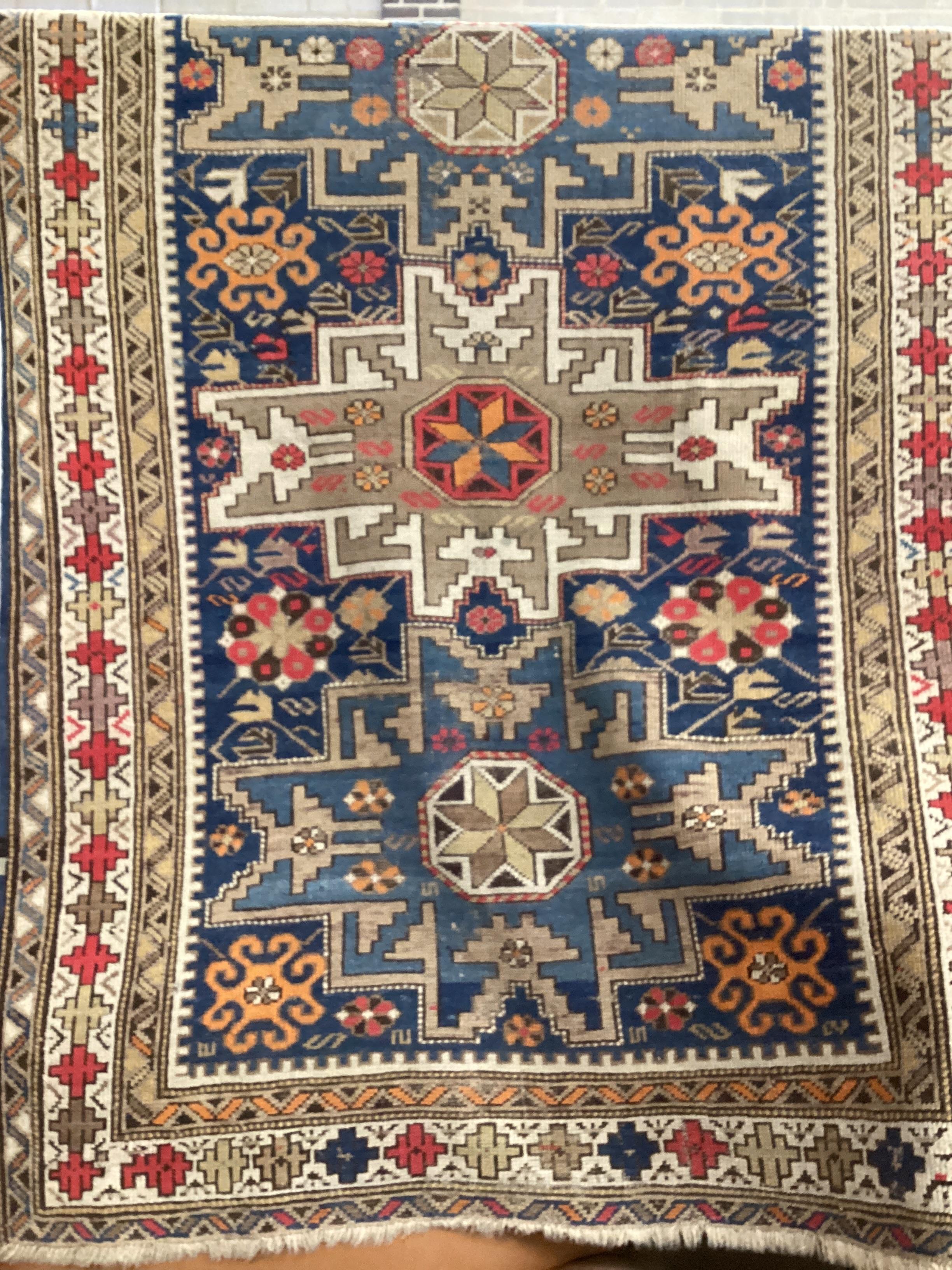 An antique Shirvan Lesghi design blue ground triple medallion rug 148cm x 106cm